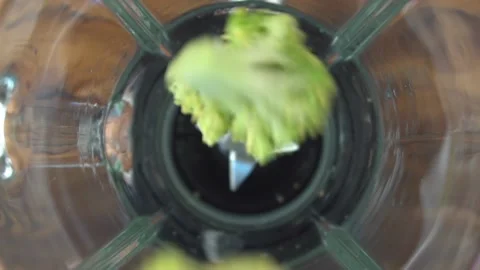 Fresh broccoli pouring in blender, close-up video Stock Footage 85664441