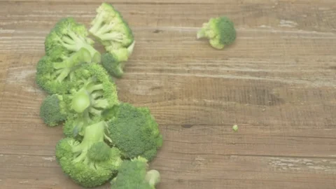 A Fresh Broccoli Vegetable Placed on a Rustic Wooden Table Ready for Culinary Stockbeeldmateriaal 284132181