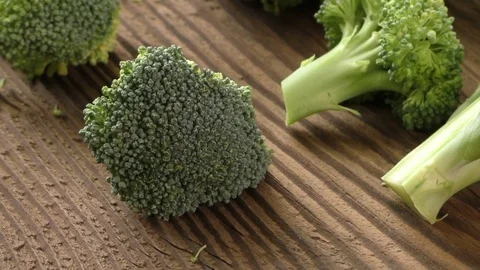 Fresh broccoli on the wooden table Stock Footage