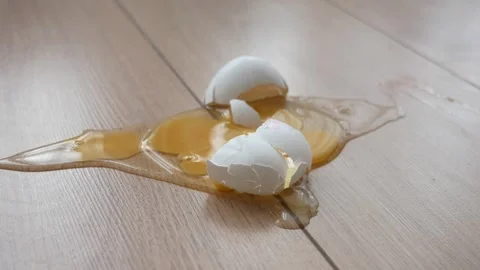 Fresh broken egg in kitchen floor Видео 293886811