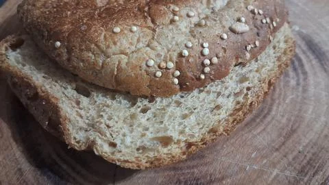 Fresh brown artisanal bread slice with crunchy seeds on top Stock Photos