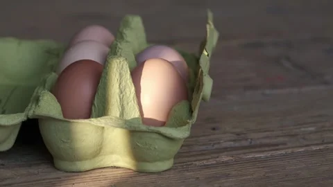 Fresh brown chicken eggs in green carton box Stock Footage 336188634