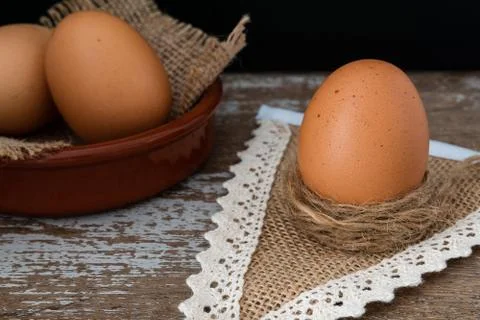 Fresh brown eggs on a rustic table,selective focus Stock Photos