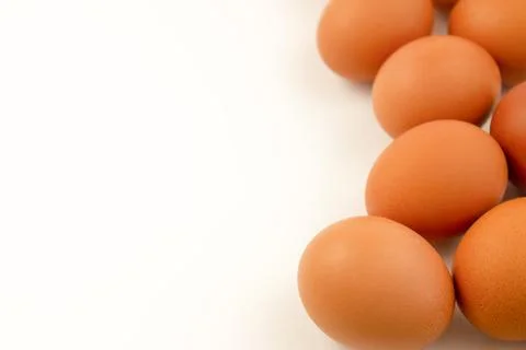 Fresh brown eggs on a white background. Copy space. Stock Photos