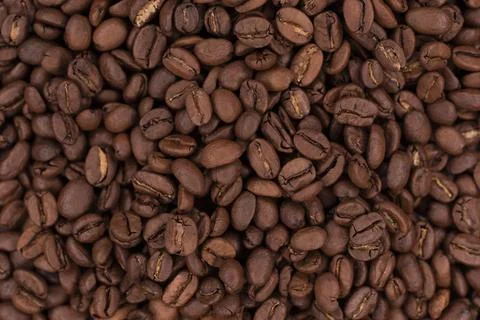 Fresh brown roasted coffee beans as a background Stock Photos