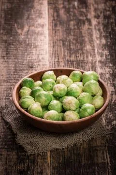 Fresh brussel sprouts over rustic wooden texture.healthy food Stock Photos