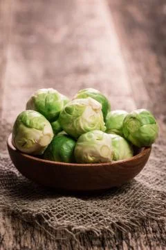 Fresh brussel sprouts over rustic wooden texture.healthy food Stock Photos