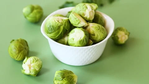 Fresh brussels sprouts composition with copy space on green background Stock Footage 334623781