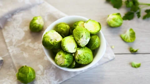 Fresh brussels sprouts composition with copy space on green background Stock Footage 334791737
