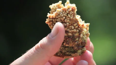 Fresh buckwheat bread in a hand turning on Stock Footage 111388504