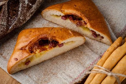 Fresh bun, sliced bun. Bread on a brown background. Rural food. Homemade past Stock Photos