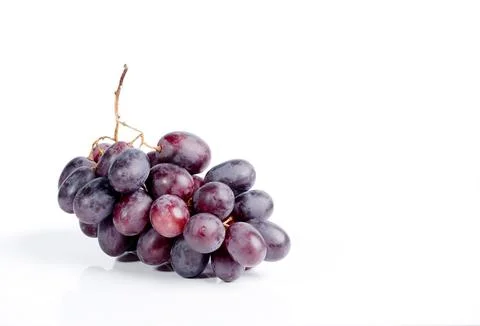 Fresh bunch of deep red grapes with a stem on a clean white background 스톡 사진