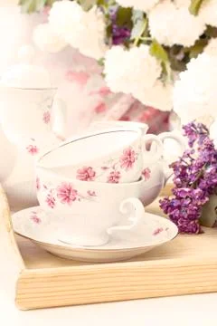 Fresh Bunch lilac with empty tea set, toned photo Stock Photos