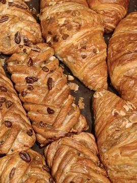 Fresh buns sprinkled with nuts displayed in a bakery, showcasing soft baked.. Stock Photos