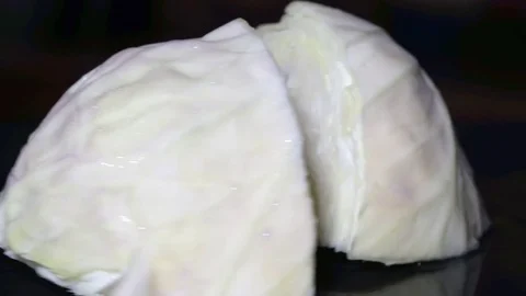 Fresh Cabbage Rotating on Black Plate Stock-Footage 79839922