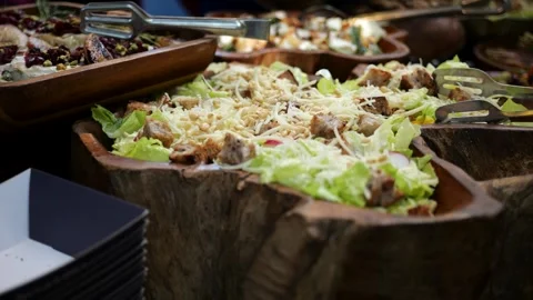 Fresh caesar salad on buffet table at catering event and restaurant service Stock Footage 337385513