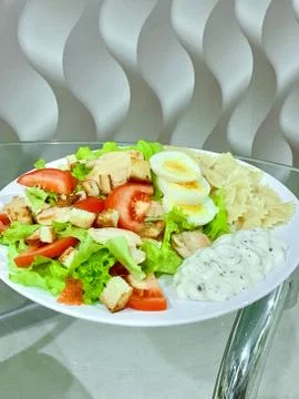 Fresh Caesar salad with chicken. Close up Caesar salad in home or dining room in Stock Photos