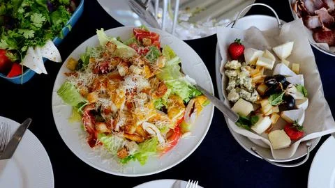 Fresh caesar salad featuring grilled chicken, crispy croutons, parmesan shavings Stock Photos