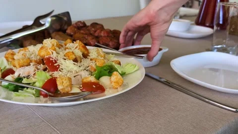 Fresh caesar salad with grilled meat and barbecue sauce on table Stock Footage 336965429