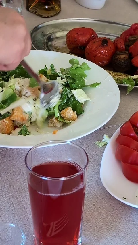 Fresh caesar salad with grilled vegetables and cranberry drink Stock Footage 337537080