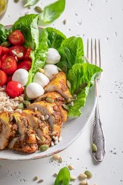 Fresh Caesar salad with tomatoes and corn and pearl barley. Stock Photos