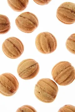 Fresh cakes walnuts pattern on a white background. Stock Photos