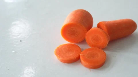 Fresh carrots cut into sections and round slices Stock Footage 337976848