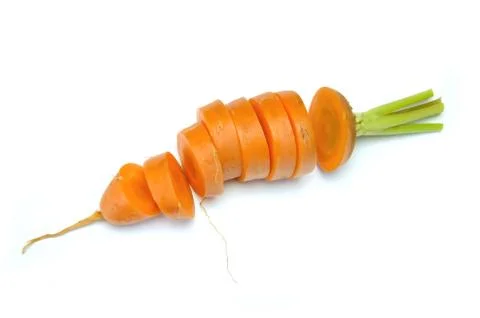 Fresh carrots without tops cut into slices on a white 写真素材