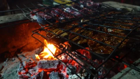 Fresh caught fish cooking on open fire in Indonesia Stock Footage 220114275