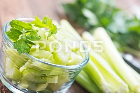 Fresh celery in glass bowl on a table Stock Photos