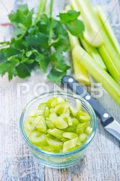 Fresh celery in glass bowl on a table Stock Photos