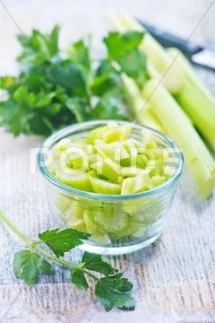 Fresh celery in glass bowl on a table Stock Photos