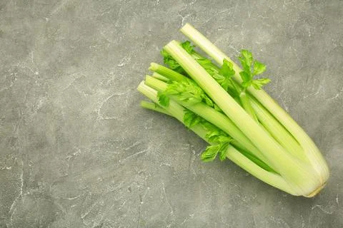 Fresh celery on grey concrete background. Stock Photos