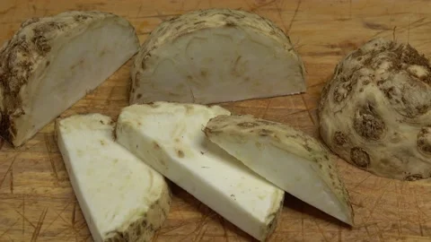Fresh celery root (apium graveolens) on a wooden cutting board Video stock 165538673