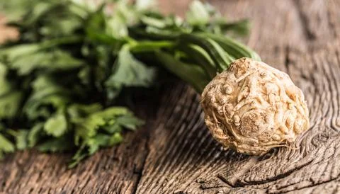 Fresh celery root with leaf on rustic oak table Stock Photos