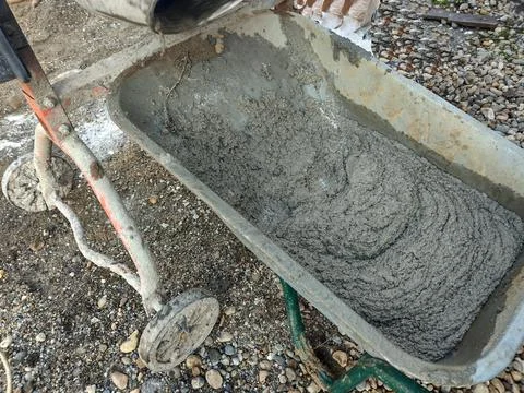 Fresh cement in a wheelbarrow 스톡 사진