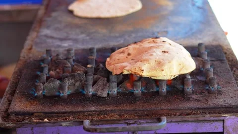 Fresh Chapati Puffing on Flame Traditional Indian Cooking Scene Stock Footage 333070018