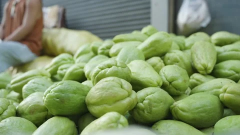 Fresh Chayote Being Placed on a Roadside Vegetable Display Stock Footage 341646123