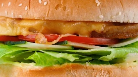 Fresh cheeseburger with vegetables, close-up view, served in restaurant Stock Footage 87791300