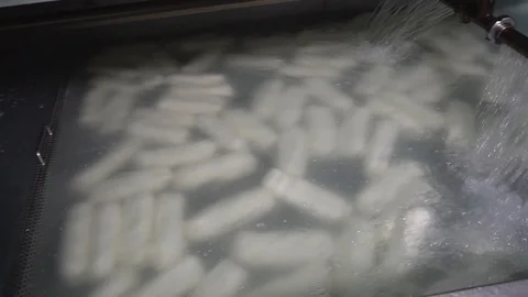 Fresh cheeses float in the water Stock Footage 129928207