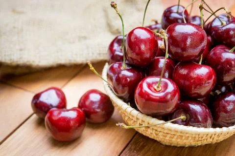 Fresh cherries in basket on table Stock Photos