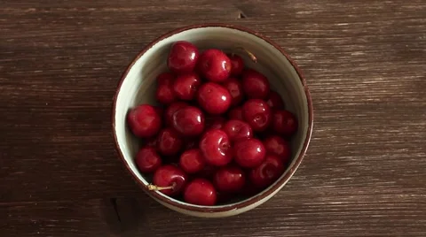 Fresh cherries in bowl on table Stock Footage