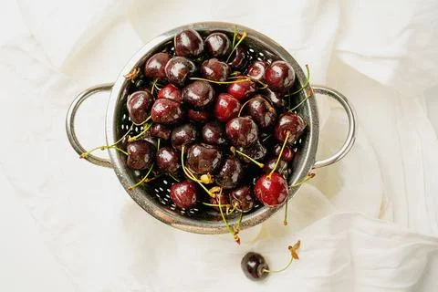 Fresh cherries in the colander Stock Photos