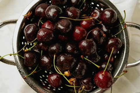 Fresh cherries in the colander Stock Photos
