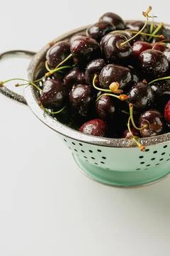 Fresh cherries in the colander Stock Photos