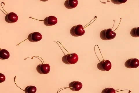 Fresh cherries pattern layout scattered on trendy beige background. Summer Foto stock