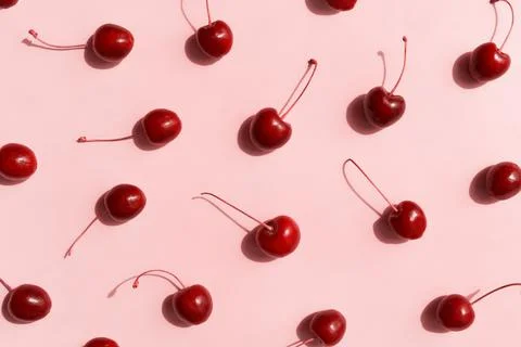 Fresh cherries pattern layout scattered on trendy beige background. Summer Stock Photos