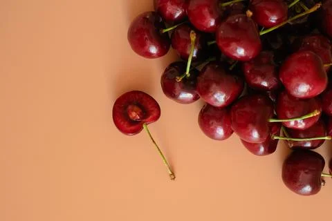 Fresh cherries on peach background Stock Photos