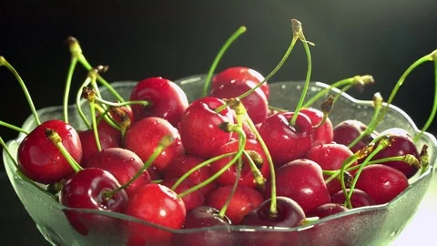Fresh cherries rotating in plate Stock Footage 76467078