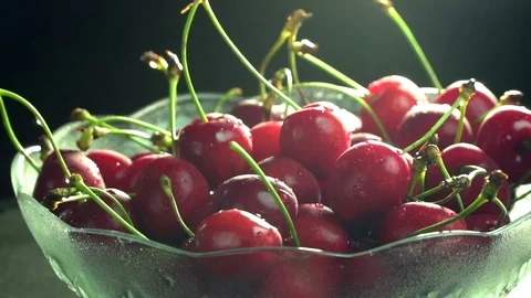 Fresh cherries rotating slow motion in plate Stock Footage 76466273
